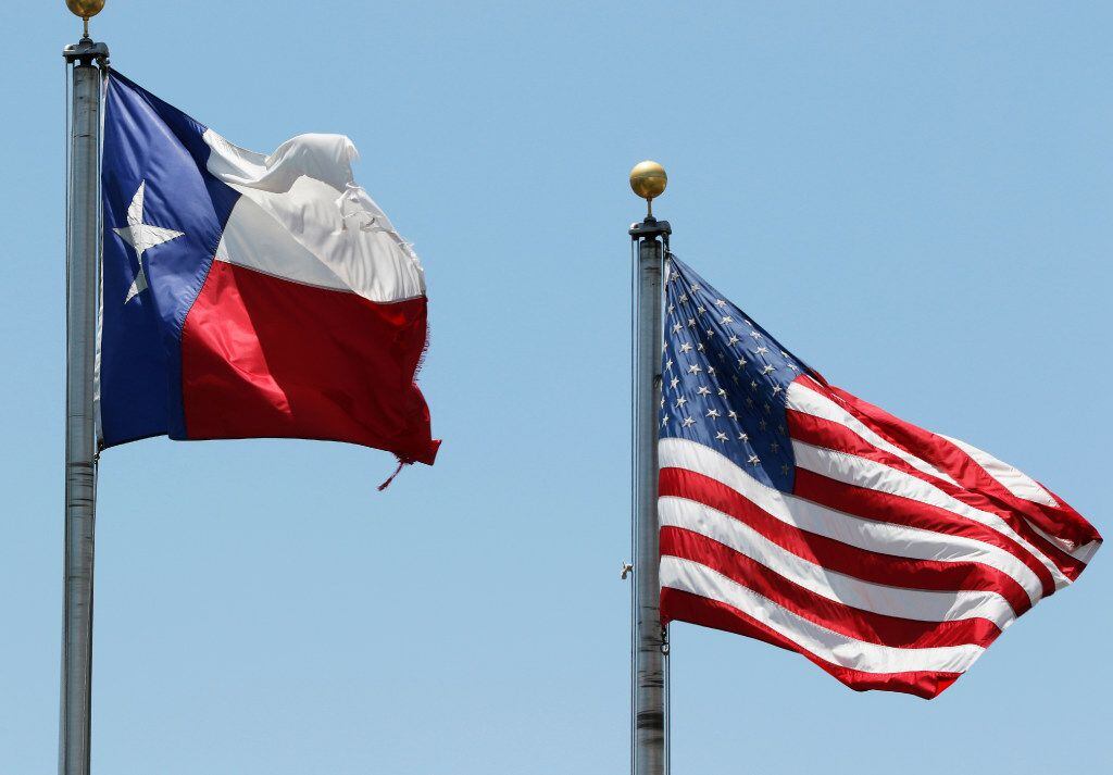 American and Texas flags are flown in Arlington. (David Woo/The Dallas Morning News)
