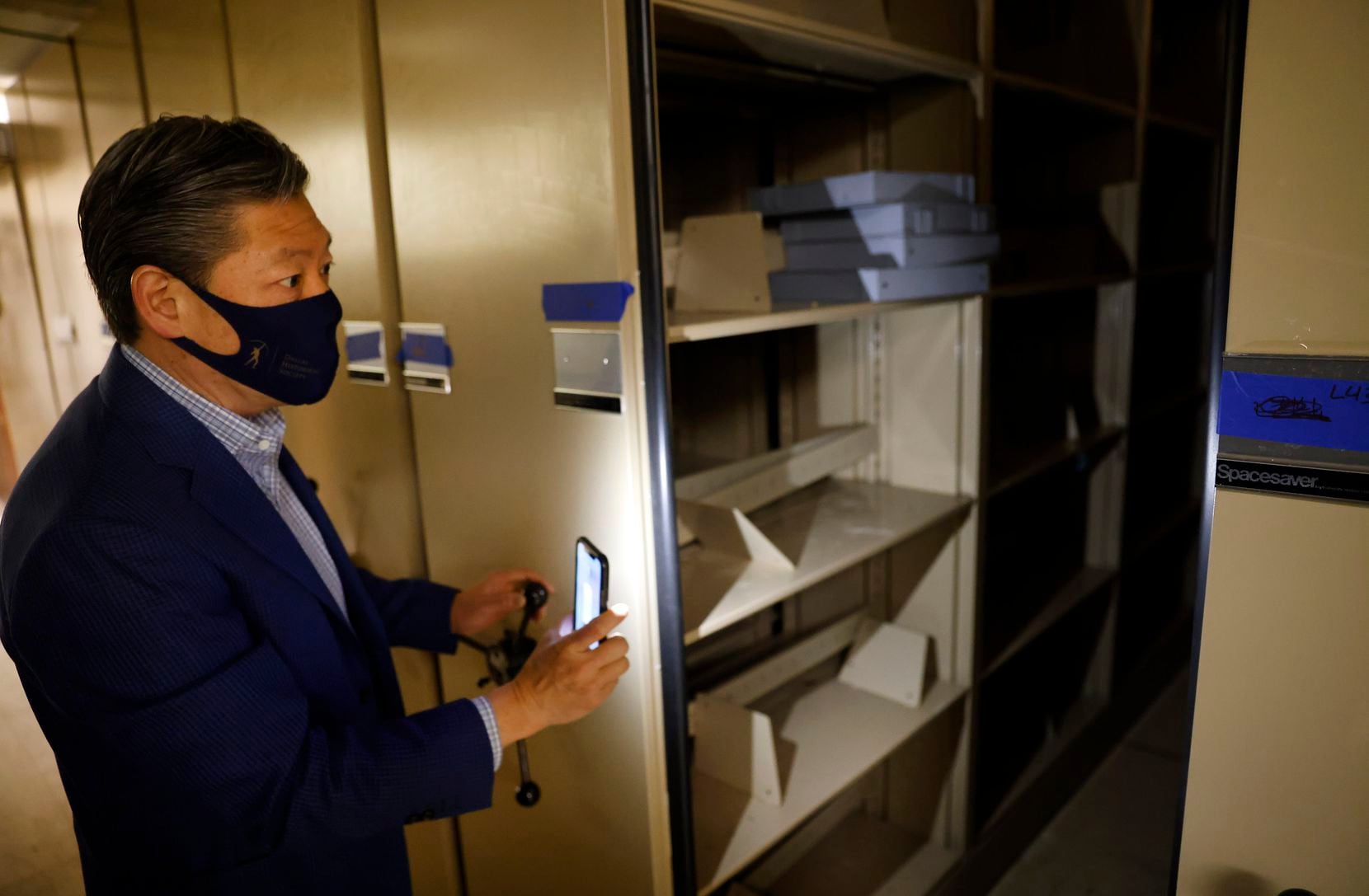Karl Chiao, the executive director of the Dallas Historical Society, tours the archive room where artifacts in rolling Spacesaver shelves went mostly untouched by the water flowing from above in the Hall of State building at Fair Park. Each shelving section has a rubber seal around it so when stacked together, water is repelled. 