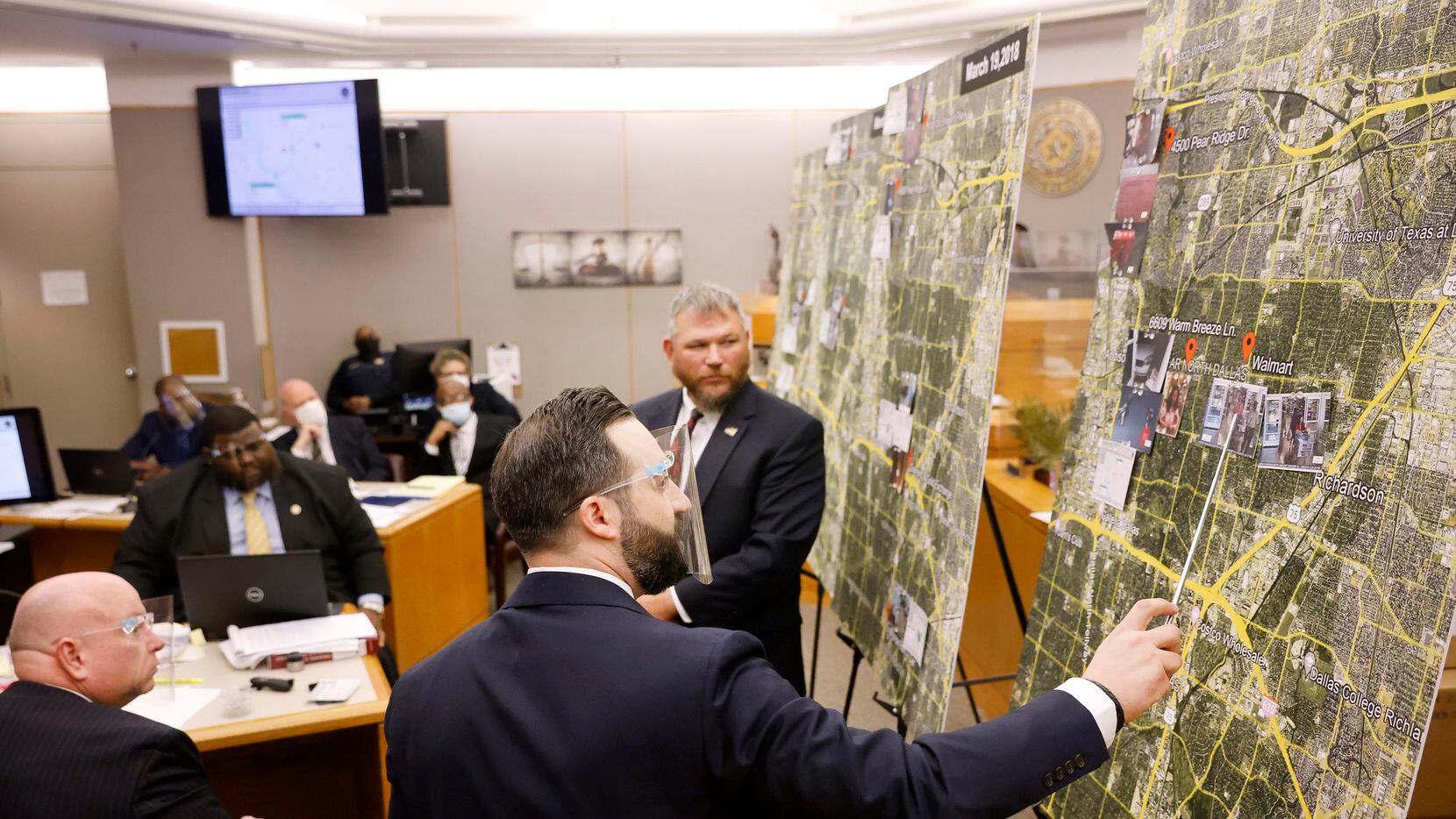 Prosecutor Dimitri Anagnostis (center) points to locations on a large map where FBI special...