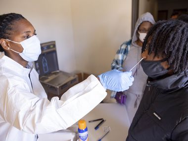 Mesquite ISD student Aviana Harrington, 13, (right) is swabbed by Crystal Baker with On Time Mobile Phlebotomist during a free COVID test provided by Mesquite ISD Health Services on Monday, Jan. 10, 2022, at the MISD Community Education building in Mesquite, TX. 