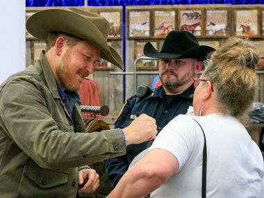 “Yellowstone” actor Cole Hauser signs the shirt of Sherry Bryant. Bryant said she it was...