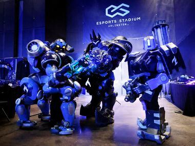 Dallas Fuel cosplay characters (from left) Orisa, Reinhardt, and Bastion pose for a photo...