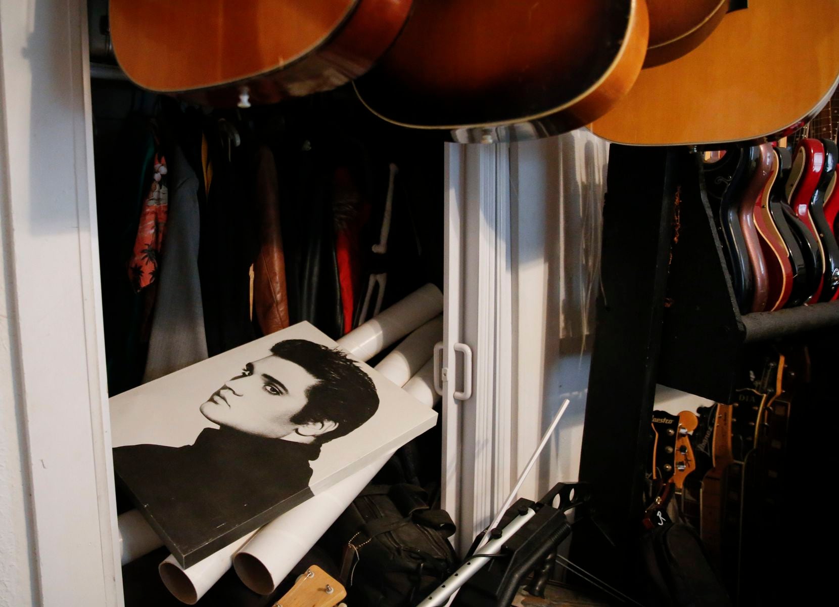A Elvis Presley portrait remain on the shelf o John Gasperik’s music memorabilia room on...