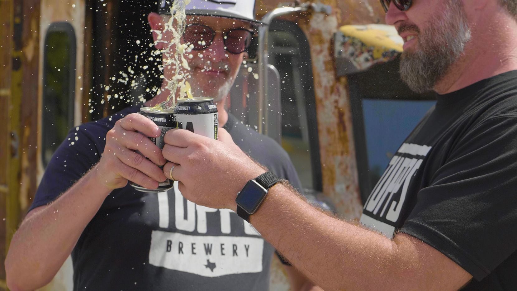 Keith Lewis, founder and president of TUPPS, and Chris Lewis, head brewer, toast outside the...