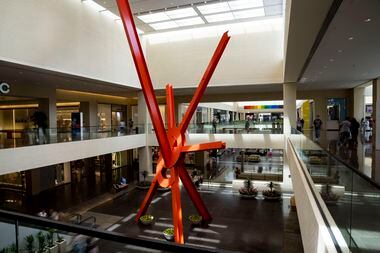 NorthPark Center is closed on Easter Sunday. Shoppers walk by "Ad Astra," a sculpture by...