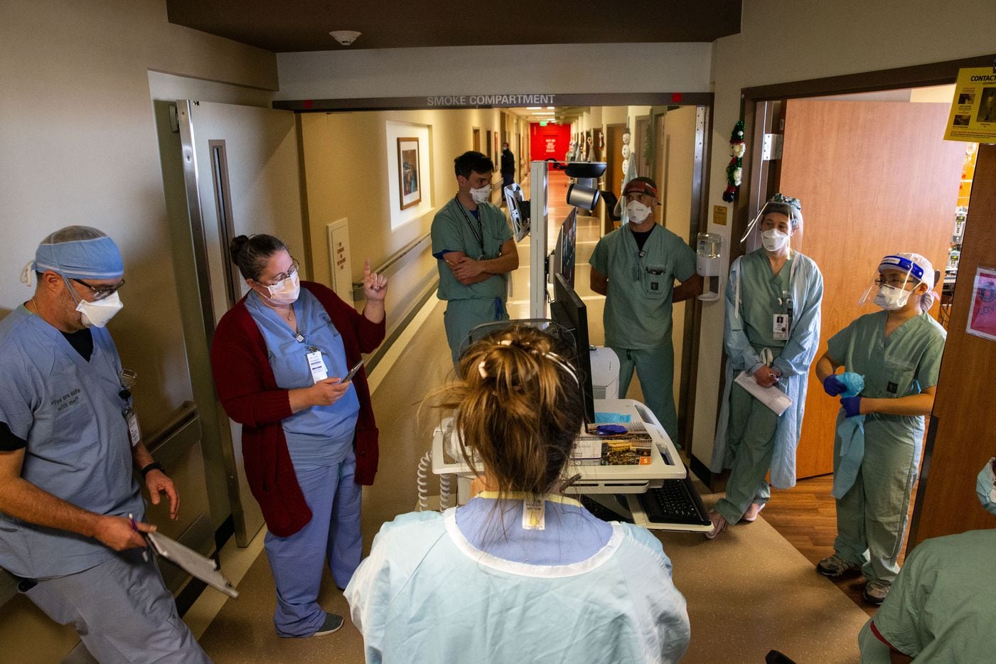 Rowley (second from left) huddles with Dr. Catherine Chen (right) and other staff members on the Progressive Care Unit of Parkland's COVID-19 Tactical Care Unit. Rowley and Chen were assessing the level of care for patients to determine whether they should be upgraded to the Intensive Care Unit or downgraded out of the TCU. “I anticipate things are going to go poorly,” Rowley said, referencing high travel numbers over the Thanksgiving holiday. “There's not going to be a single thing we can do to stop it. And all we can do is hope that we can keep enough people alive that can defeat this disease.”