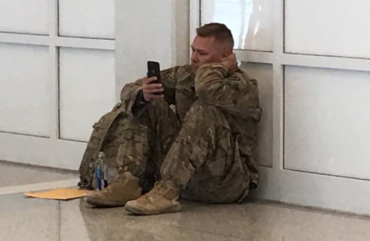 Soldier Brooks Lindsey, shown at DFW International Airport, watches on FaceTime as his wife...