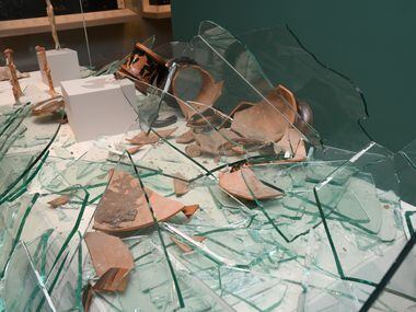 Shards of the amphora Hernandez allegedly broke are shown scattered across a display case.
