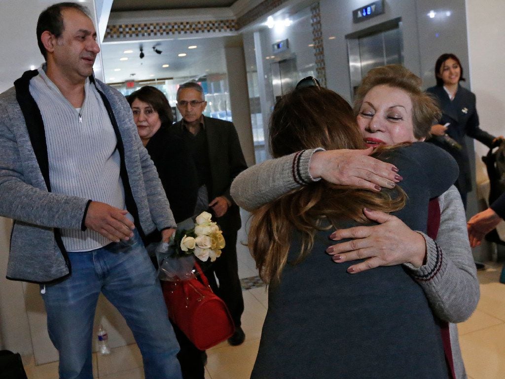 Shahin Hassanpour of Iran (right, facing camera) gets a hug from Anahita Bahrami of Dallas...