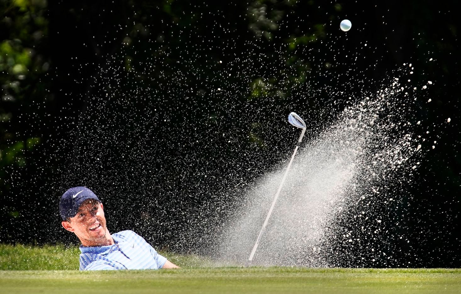 PGA Tour golfer Rory McIlroy hits out of the No. 11 green side bunker during the third round...