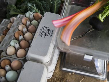 Fresh eggs, along with chard and radishes from Bonton Farms is on sale at the Dallas Farmers Market on Saturday, March 14, 2020.