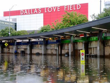 Rental car and shuttle pickup/drop off lanes in the lower level with flooded water at Dallas...