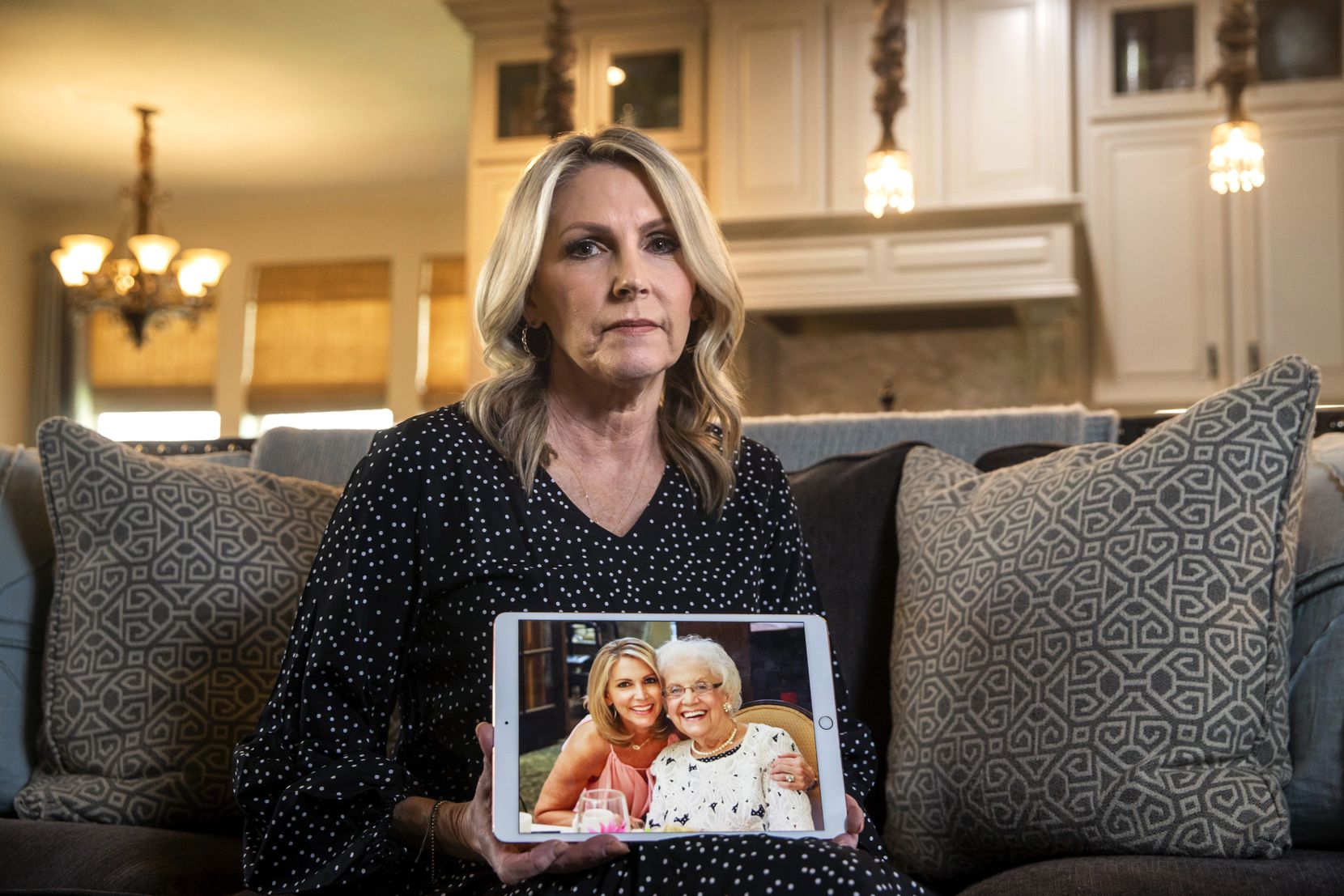 Cheryl Pangburn holds a photo of her and her mother, Marilyn Bixler — taken at luxury senior living community Parkview in Frisco — at Pangburn’s home in Frisco.