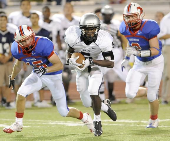 Irving Nimitz's JJ Gaines (5) runs past Richardson Pearce's Sam Dempsey (15) and Bryce Henderson (2) in the second quarter of a Sept. 3, 2010, game at Eagle-Mustang Stadium in Richardson.