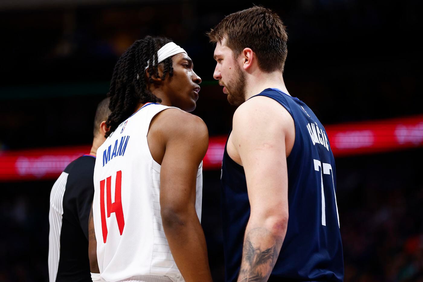 LA Clippers guard Terance Mann (14) and Dallas Mavericks guard Luka Doncic (77) get in each others face during the second half of an NBA basketball game in Dallas, Saturday, February 12, 2022. LA won 99-97. 
