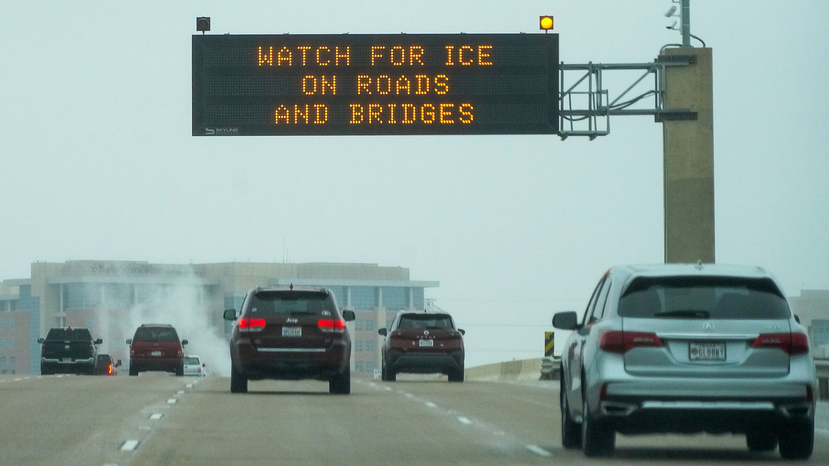 Signs on the Bush Turnpike warn of icy driving condition on Monday, Jan. 30, 2023, in Plano....
