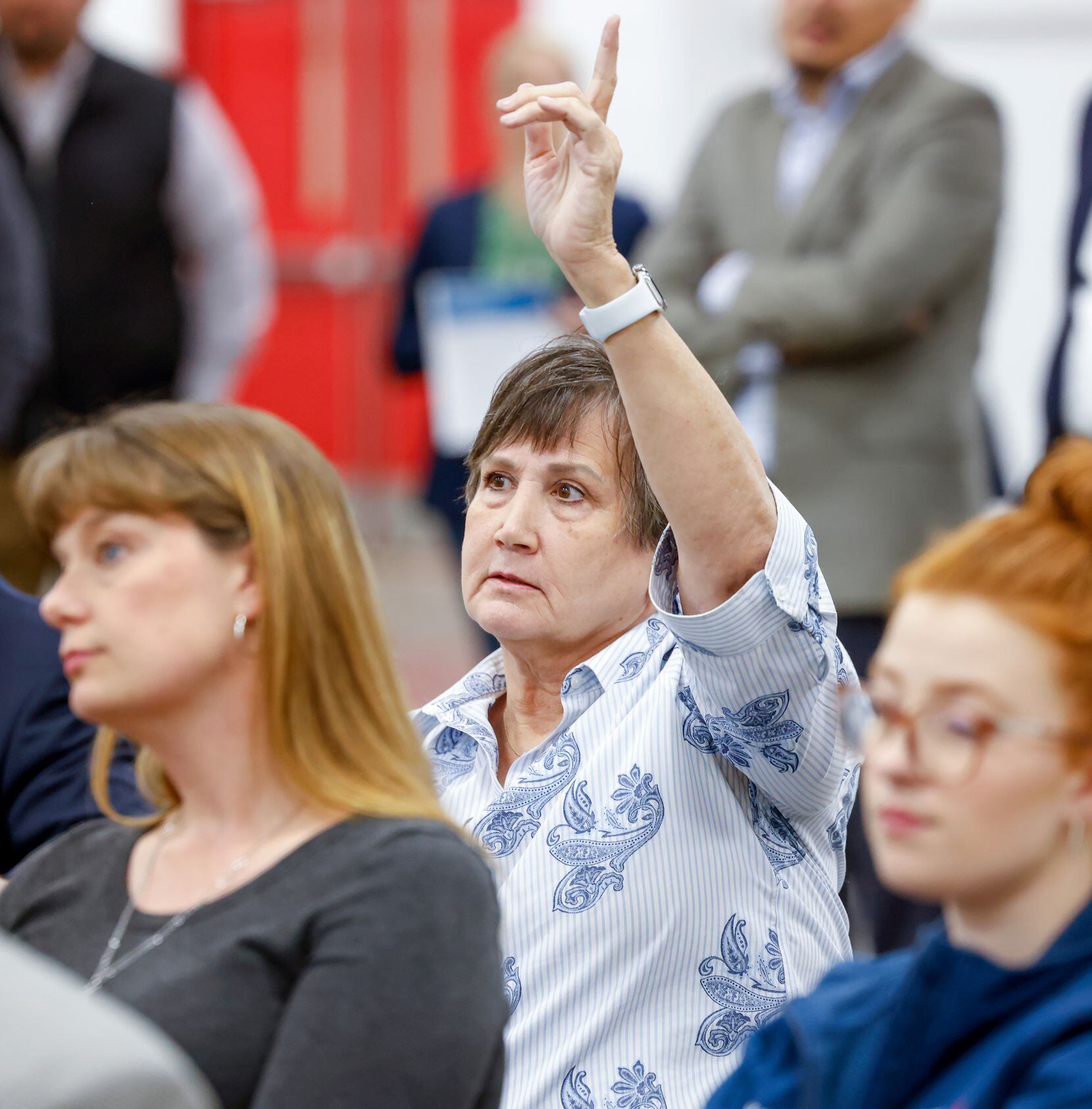 Fort Worth resident LaVonne Cockerell raises a hand to ask a question on the process for...