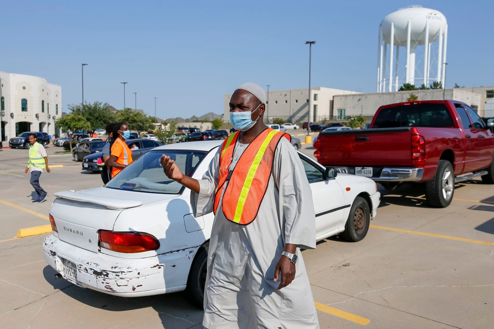 Kamal Hassan, Islamic Center of Irving outreach leader, directed cars during a food bank...