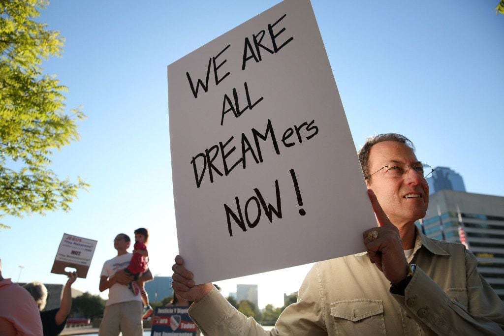 Noel Pullam held a sign during a rally for DACA recipients at City Hall Plaza in Dallas last...