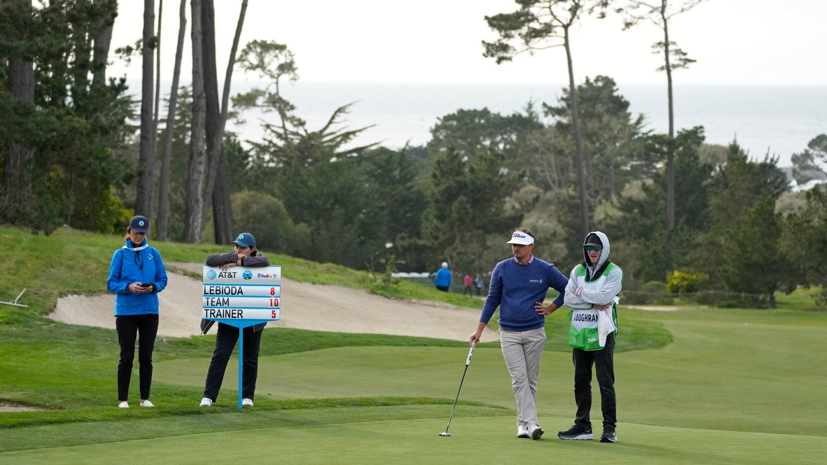 Hank Lebioda, second from right, waits to putt on the 18th green of the Monterey Peninsula...