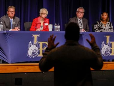 Little Elm ISD Superintendent Daniel Gallagher, far left, and other school officials listen to a parent during a listening session on the response to a high school student protest that led teenagers being sprayed with pepper spray and a tasé.