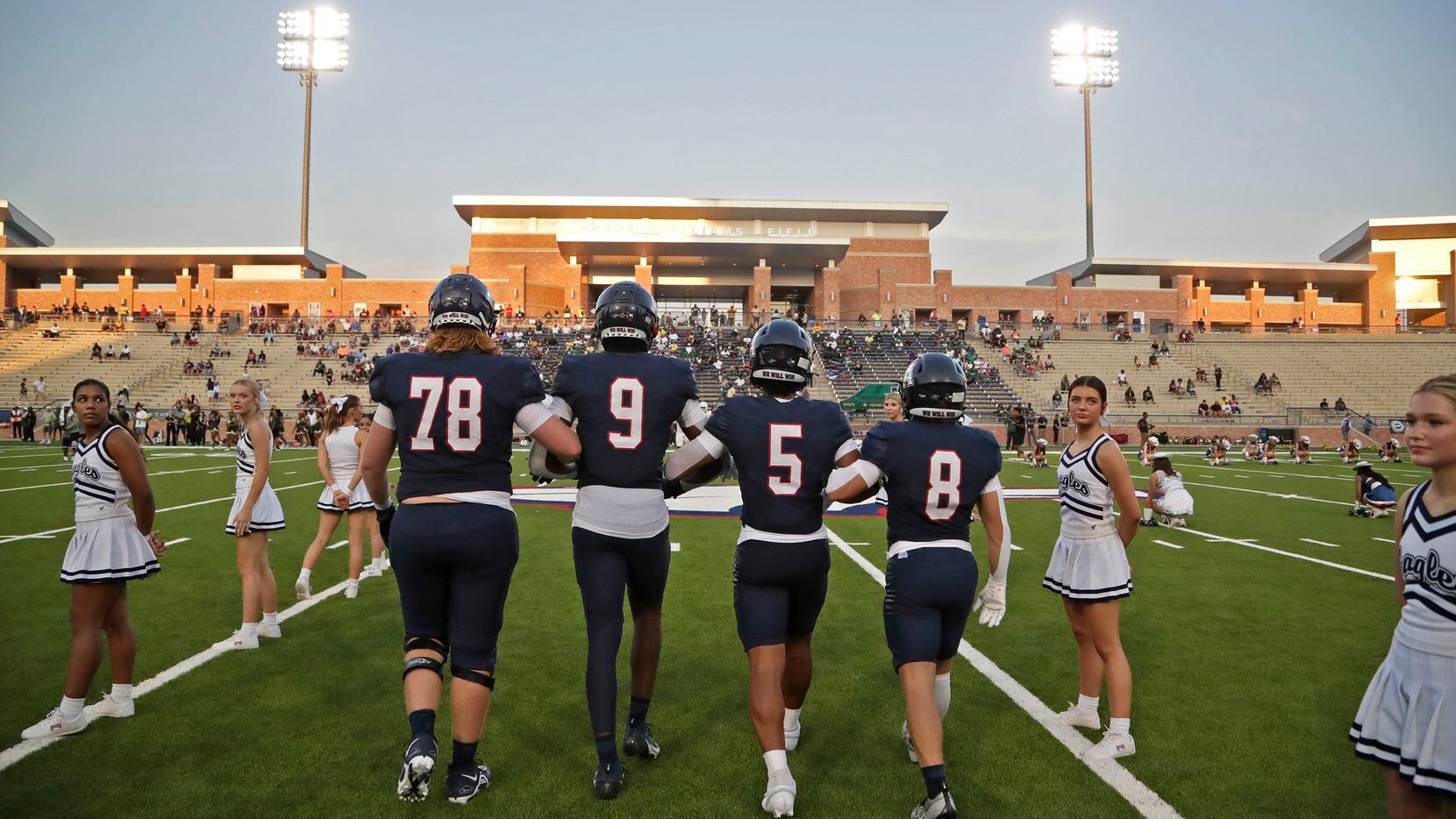 Allen High School captains head to the coin toss before kickoff as Allen High School hosted...