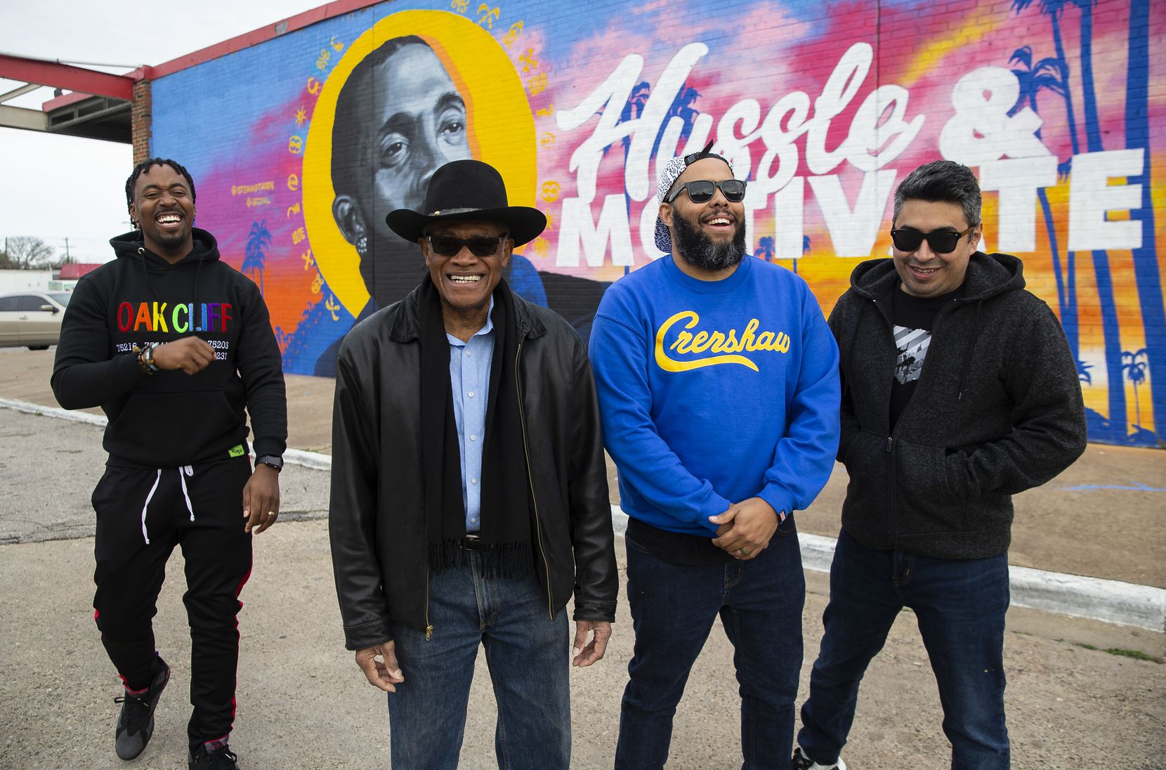 (From left) Taylor Toynes, executive director of For Oak Cliff, Al Herron, Glendale Shopping Center owner, and artists Jeremy Biggers and Hatziel Flores pose in front of the mural dedicated to the late rapper, entrepreneur and community activist Nipsey Hussle at the Glendale Shopping Center on Feb. 22, 2020 in Dallas.