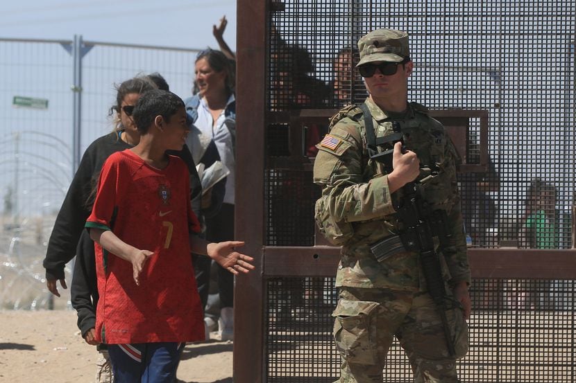 Border Patrol agents and the Texas National Guard open Gate 42 in May on the border near El...