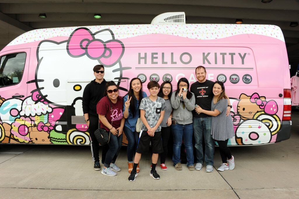 Friends take pictures in front of the famous truck at the Hello Kitty Cafe Truck at The...