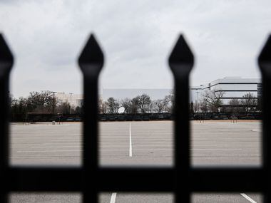A locked fence and empty parking lot sat in the 2200 block of Burbank Street in Dallas on...