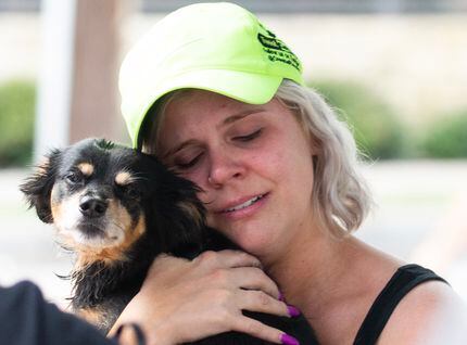 Corey Lark gets emotional after being reunited with her dog, George, after a crane collapsed...