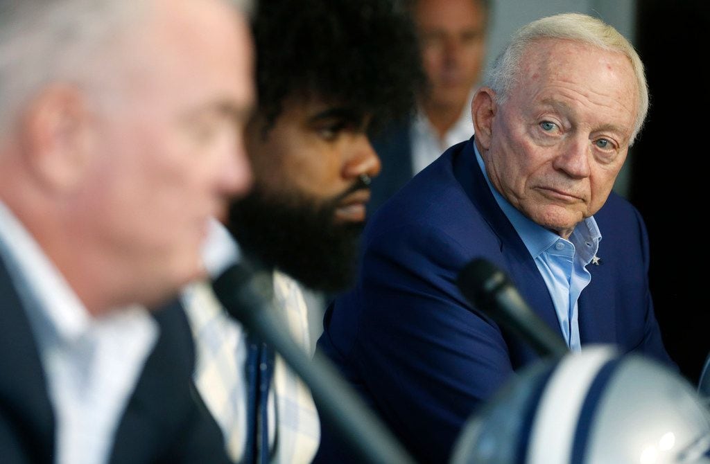 Dallas Cowboys owner and general manager Jerry Jones listens as Dallas Cowboys executive vice president Stephen Jones talks about Dallas Cowboys running back Ezekiel Elliott (21) (center) during a press conference about Elliott's contract extension at The Star in Frisco, Texas on Thursday, September 5, 2019.