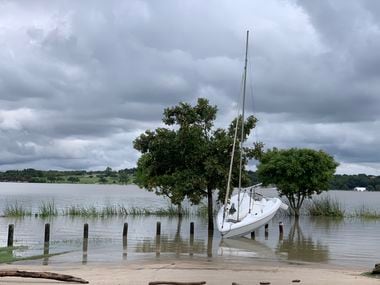 A sailboat washed up on the west shore of White Rock Lake in Dallas on Saturday.