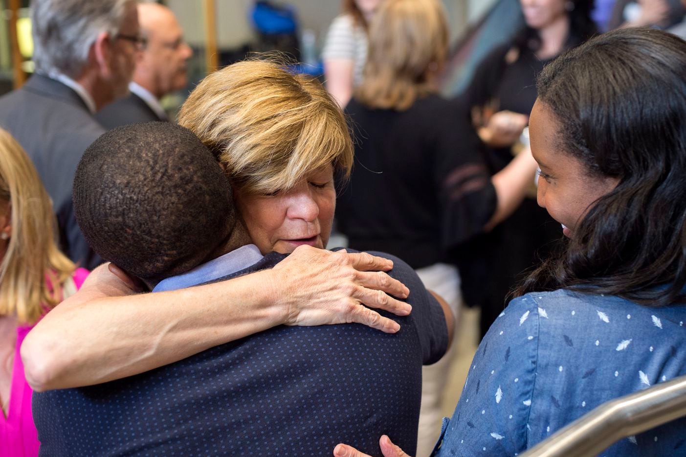 Dallas Morning News columnist Sharon Grigsby hugs lawyer Chequan Lewis before a forum on...