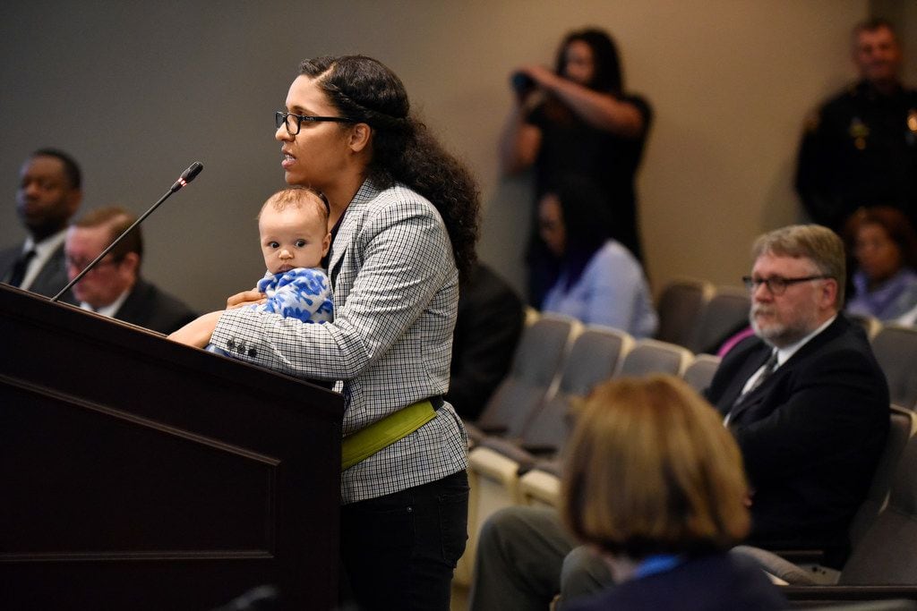 Candace Valenzuela, 34, of Dallas, with her baby, Jacinto Baldwin, speaks to members of the...