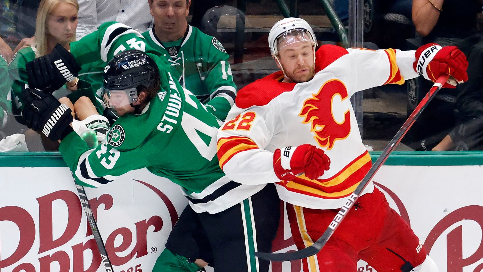 Dallas Stars left wing Marian Studenic (43) is chocked against the boards by Calgary Flames...
