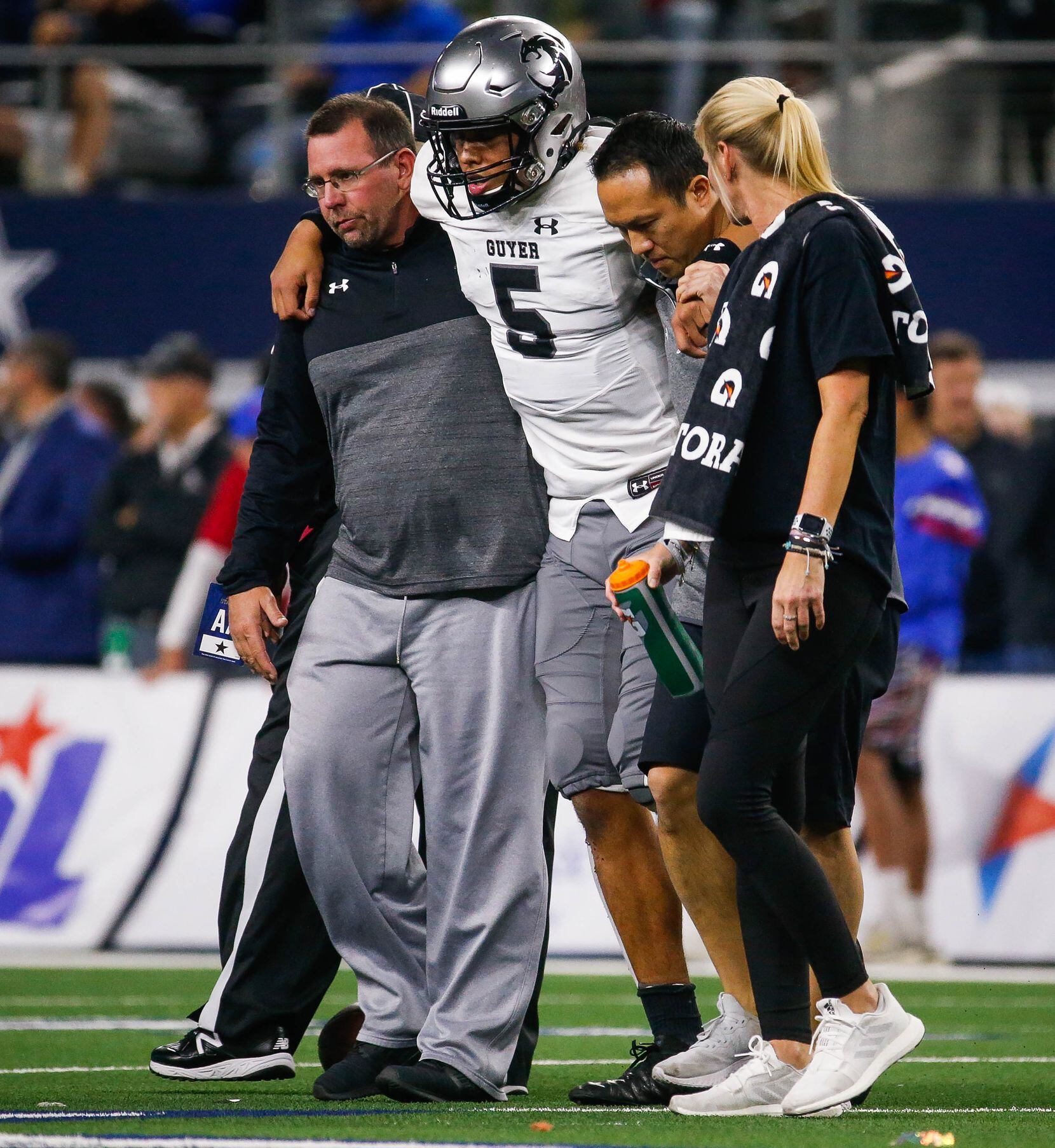 Denton Guyer's quarterback Eli Stowers (5) is led off the field after getting injured in in...