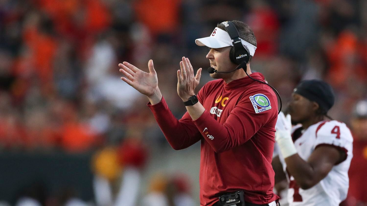 Southern California coach Lincoln Riley applauds during the first half of the team's NCAA...