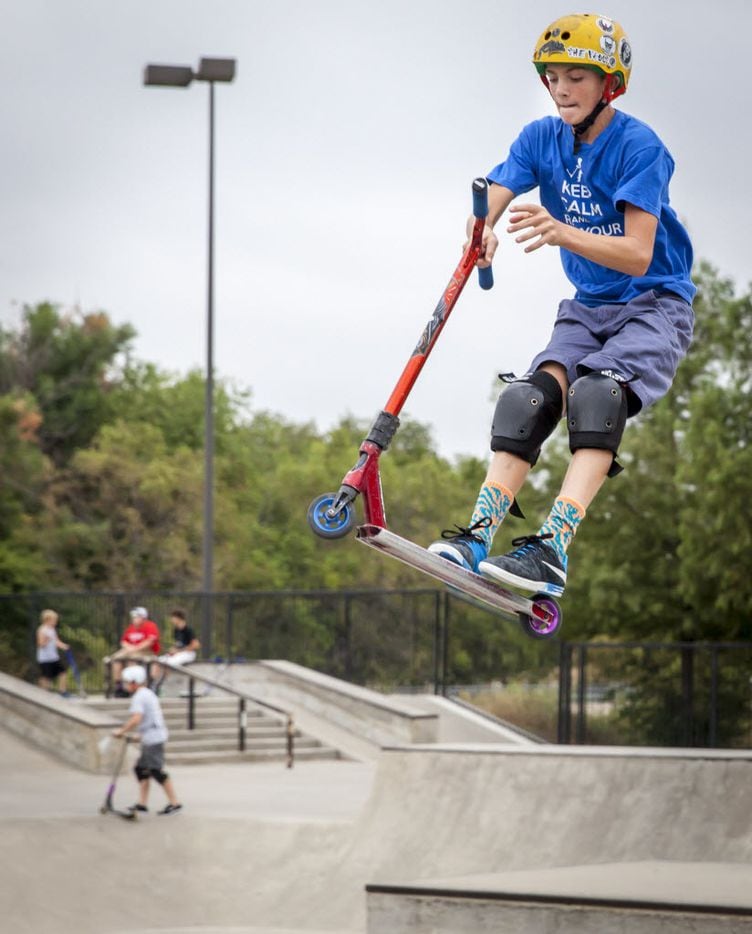 Johnny Shaffer rides his scooter during family night at The Edge Skate Park in Allen. Many...