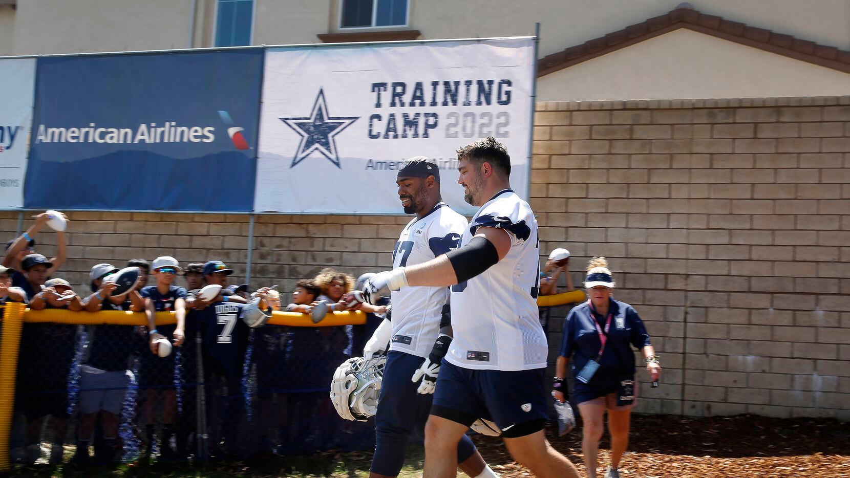 Dallas Cowboys offensive tackle Tyron Smith (77) and offensive guard Zack Martin (70) walk...