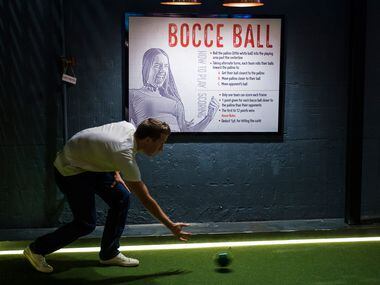 Josh Winkler plays bocce ball at Sidecar Social during its soft opening.