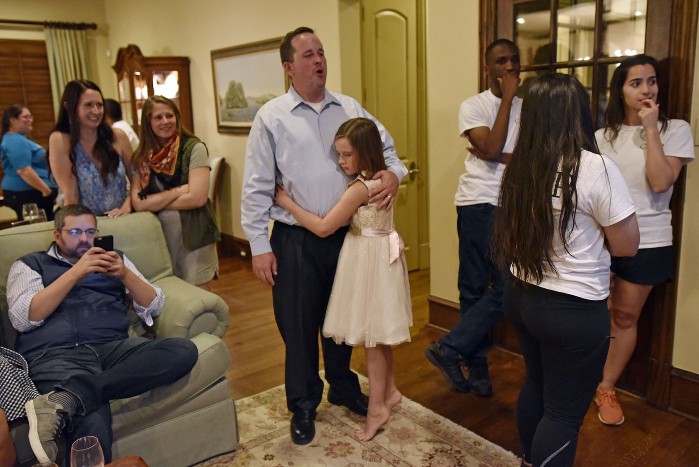 Dustin Marshall, candidate for DISD District 2, consoles his daughter Lilianna Marshall, 9,...