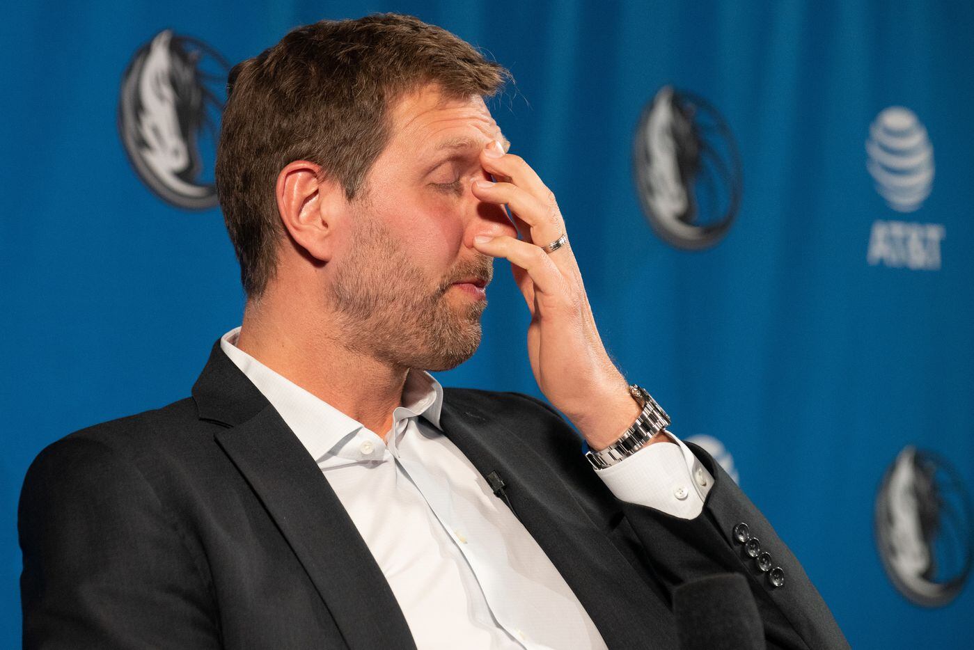 Former Dallas Mavericks player Dirk Nowitzki rubs his eyes as they fill with tears while...