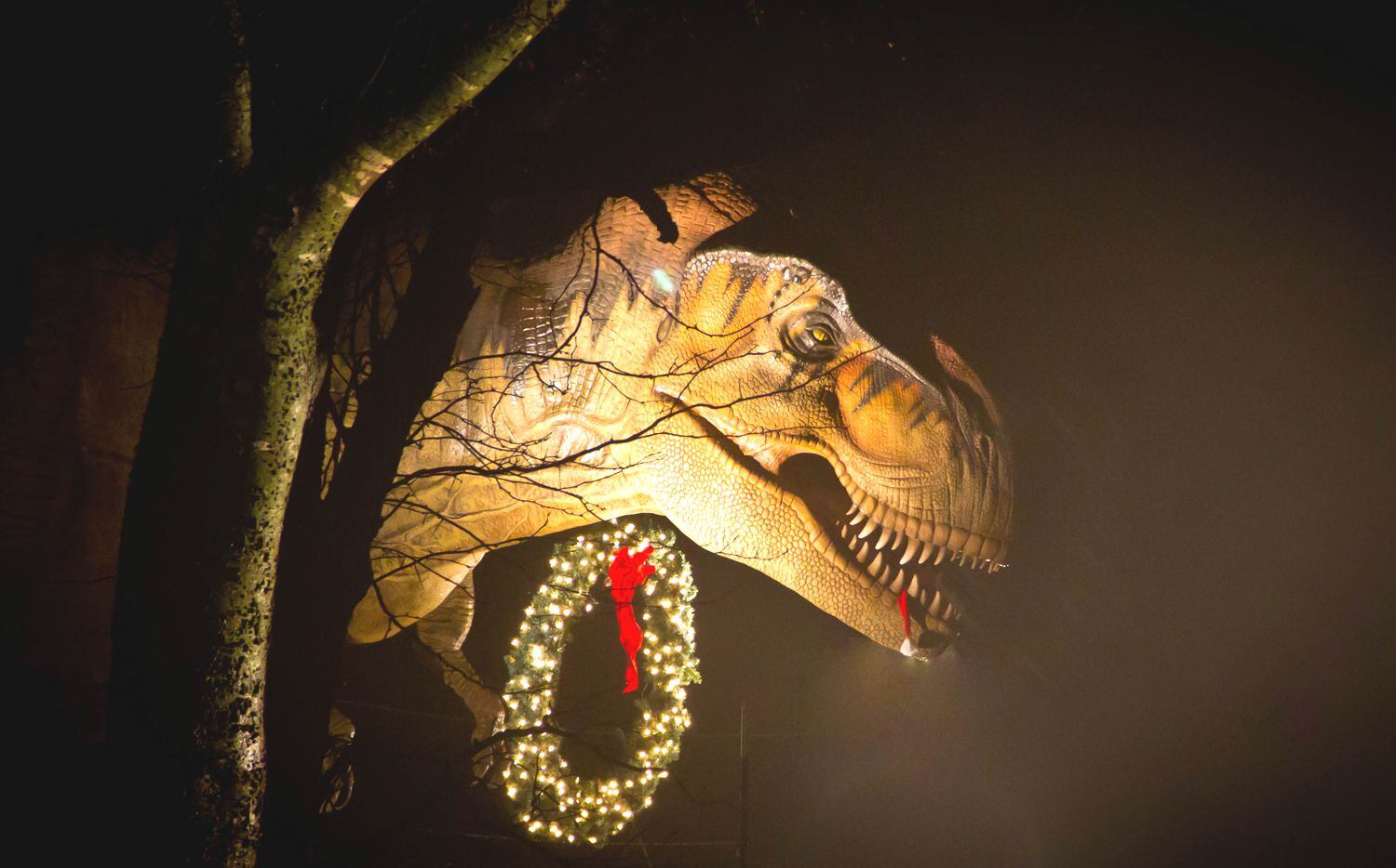 A Tyrannosaurus rex decked out in holiday décor