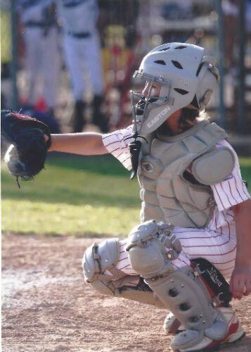9-year-old Sarah Hudek playing baseball.