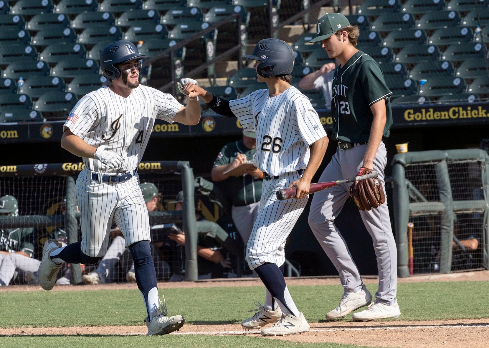 Keller Aidan Connors, (4), left, celebrates with base runner, Colten Vargas, (26), after a...