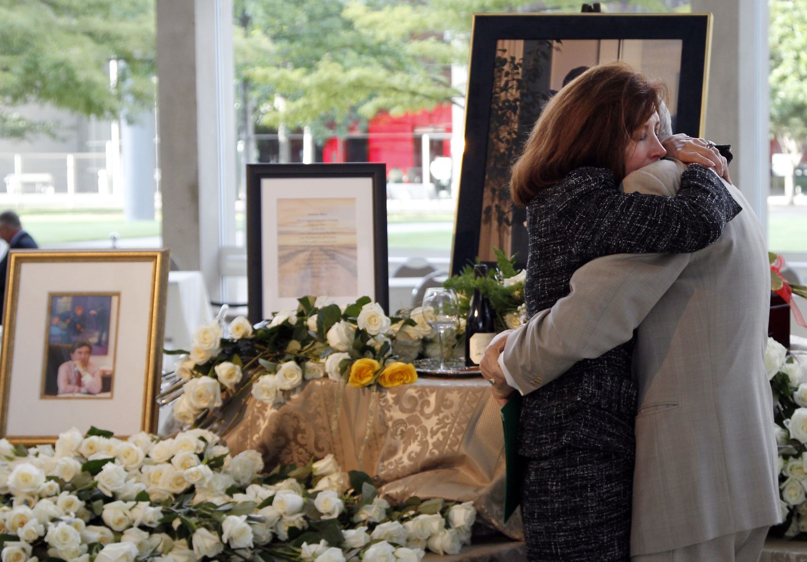 Dr. Peter T. Ivanovich consoles Betty Osborne after Burl Osborne's memorial service on...