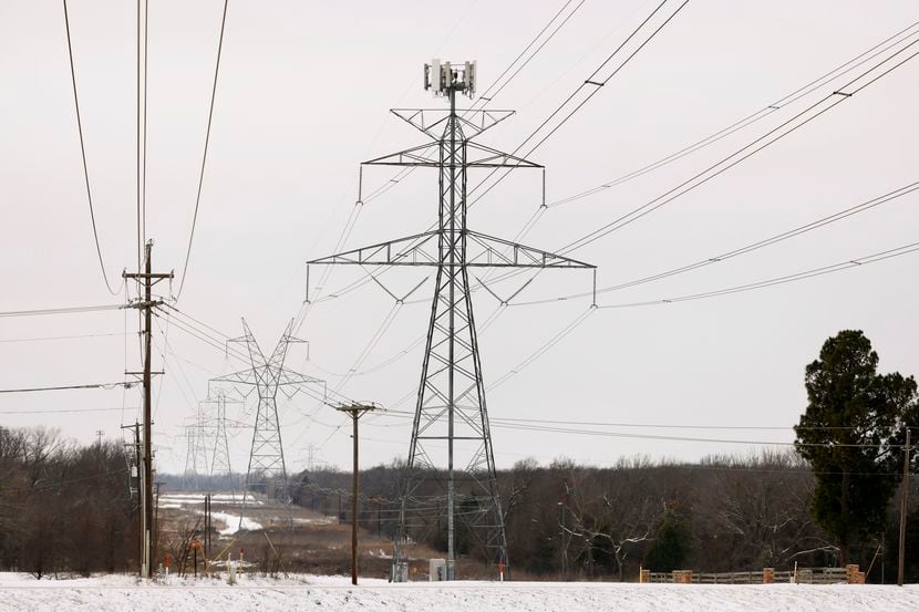 Large electrical transmission lines cross through South Arlington, Texas, on Feb. 17, 2021....