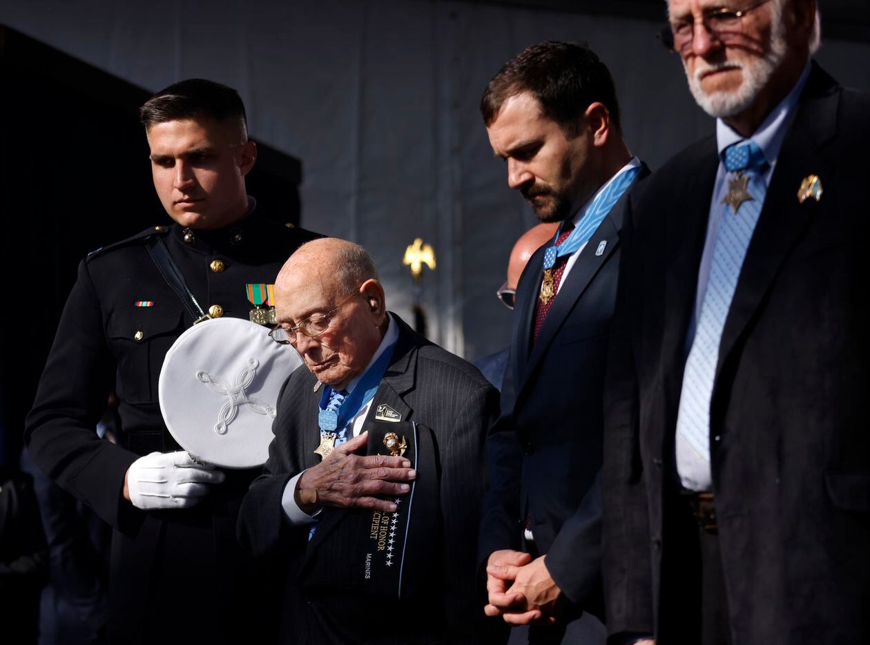 Flanked by Marine Corps Capt. Nicholas Maguire (left), World War II Medal of Honor recipient...