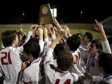 Coppell player cheer after receiving their trophy for their win over Lake Travis at the UIL...